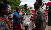 Survivors of flooding receive a food distribution of corn soya blend at Kalima Camp in Chikwawa district, Malawi.