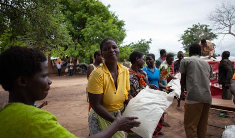 Survivors of flooding receive a food distribution of corn soya blend at Kalima Camp in Chikwawa district, Malawi.