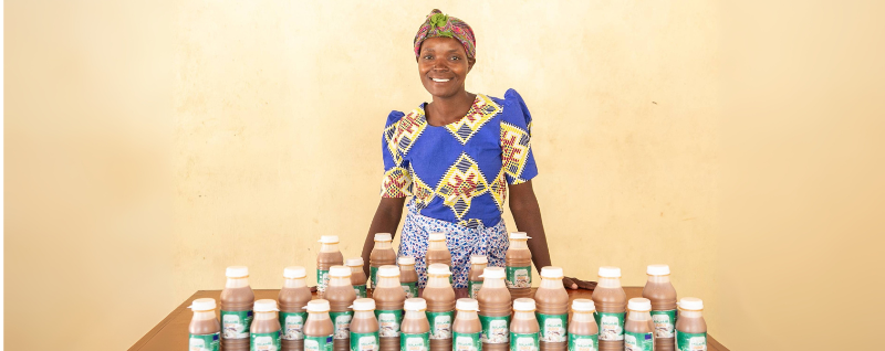 Janet, 31, showing off all the bottles of baobab (malambe) juice that she and her fellow Makande Women's Group members have made at their processing unit in Ngabu Traditional Authority, Chikwawa District, Southern Malawi, in March 2021.
