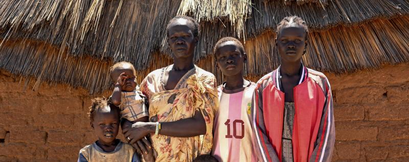 Akech and family outside their home 